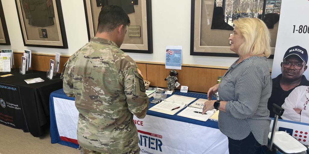 Peggy Pionke, Readjustment Counsellor at the Providence Vet Center, speaks to a member of the 43rd MP Brigade about Vet Center services at the VA Providence PDHRA