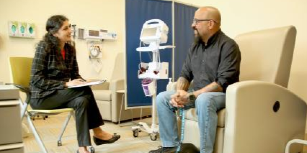 Pictured in photo: During an appointment, Psychiatrist Dr. Roopa Chavda and U.S Army Veteran Edgardo Rosa discuss his experience with Esketamine treatment.