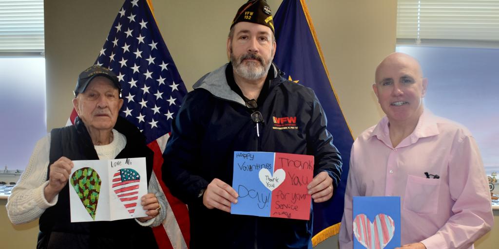 Director Lawrence Connell and VFW Post 152 member Matthew McCoy share Valentine's Day cards with WWII Navy Veteran George Silva.