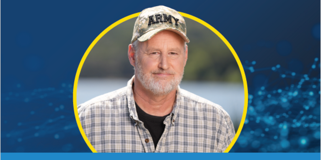 Great American Spitout person with gray bear wearing a Army baseball cap on their head and a plaid shirt, inside a yellow circle with blue background