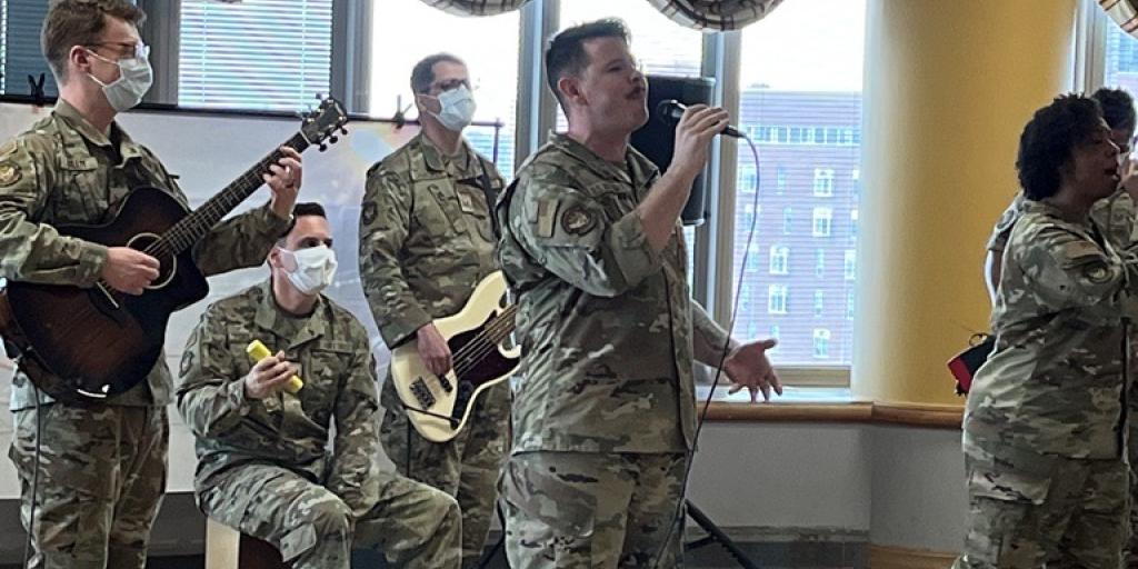 Uniformed band members play music in a room at VA Detroit
