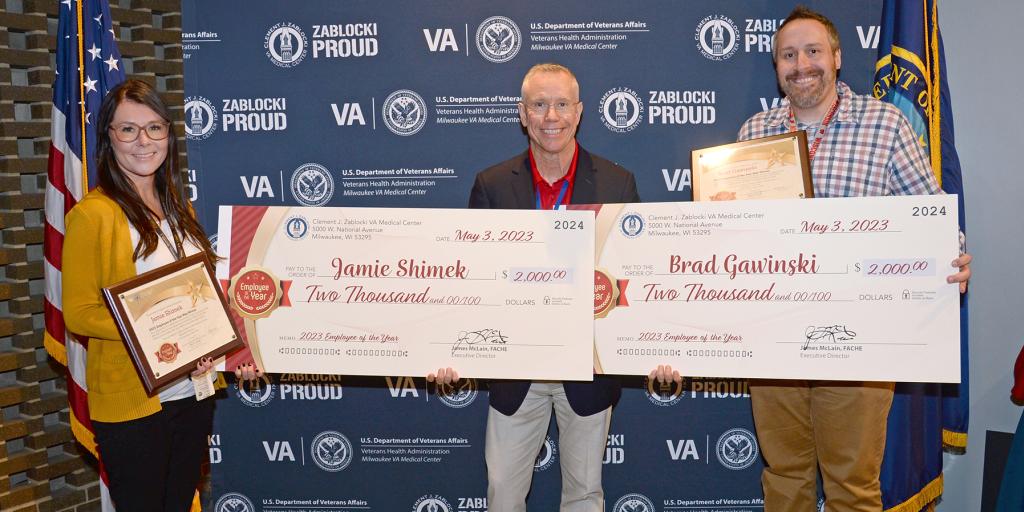 Employee of the Year winners display their checks