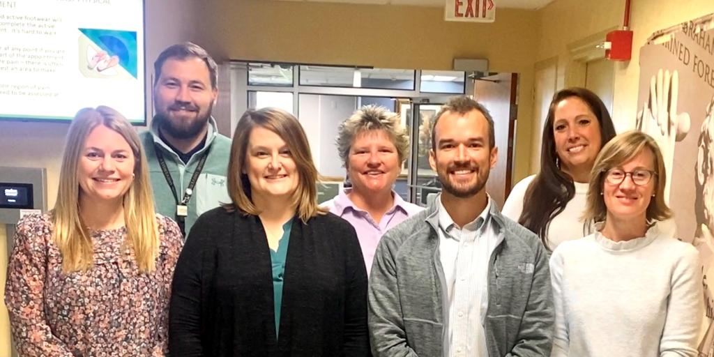 Patient Safety Team standing together and smiling for their photo op. 