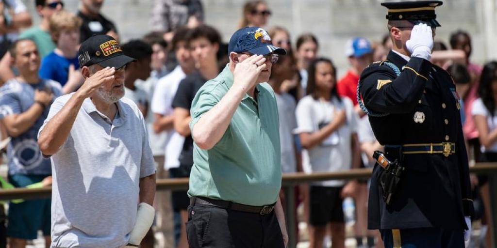 Maj. Gen. (Ret) Ronald Sweeney, and Spec. (Ret) John R. Pressler salute when an Army bugler sounds Taps that the Tomb of the Unknown Soldier