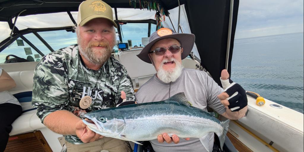 Two men show fish