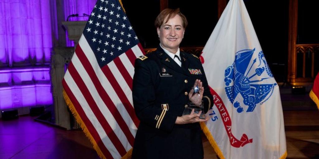 Army Reserve Lt. Col. Darcie Greuel holds Hero of Military Medicine award following ceremony at the Washington National Cathedral in Washington, D.C.