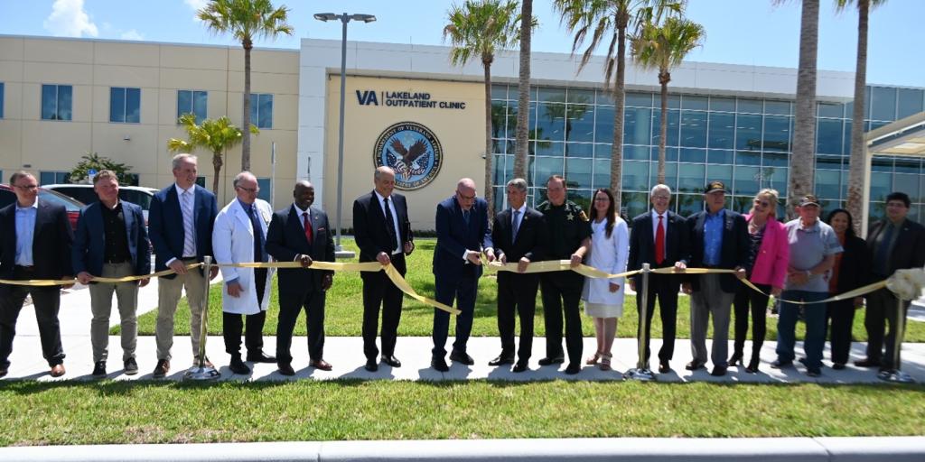 Distinguished guests and JAHVH leadership gather to cut the ribbon at the new Lakeland Outpatient Clinic on July 26, 2024.