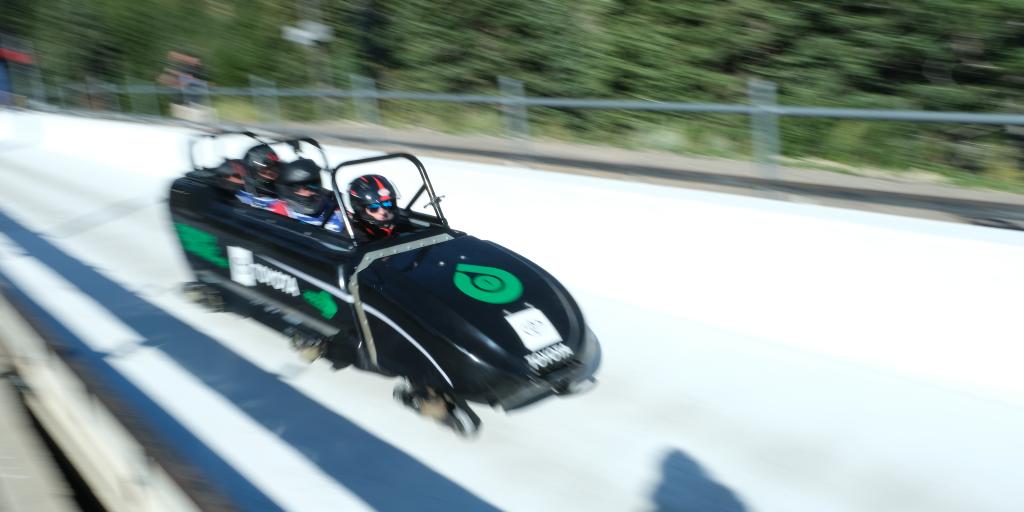 3 Veterans riding a bobsled