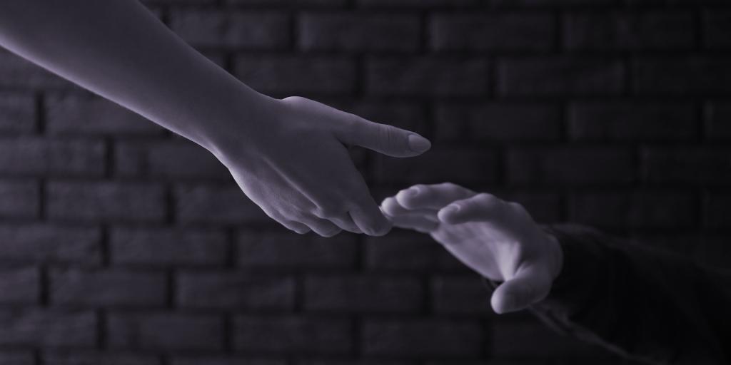 Hands reaching for each other