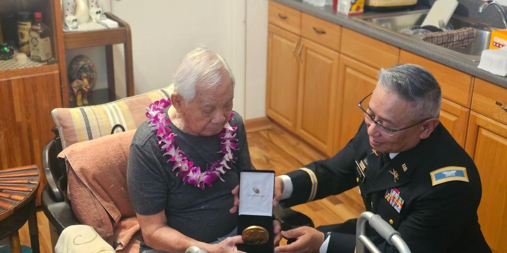 Medal being presented to WWII Veteran.