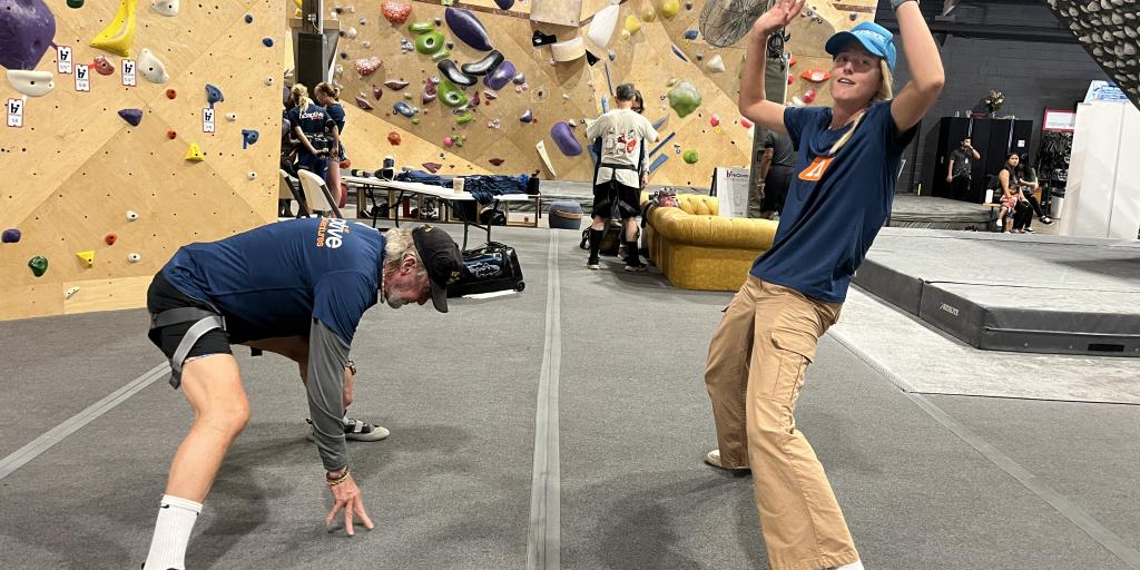 VAPIHCS Recreation Therapist Rachel Wilson leads Veterans in stretching as they prepare for the rock climbing competition. 