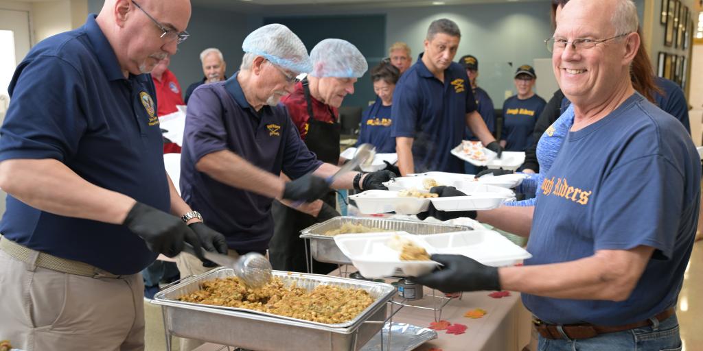 Staff and Veterans hand out or receive food for thanksgiving holiday.