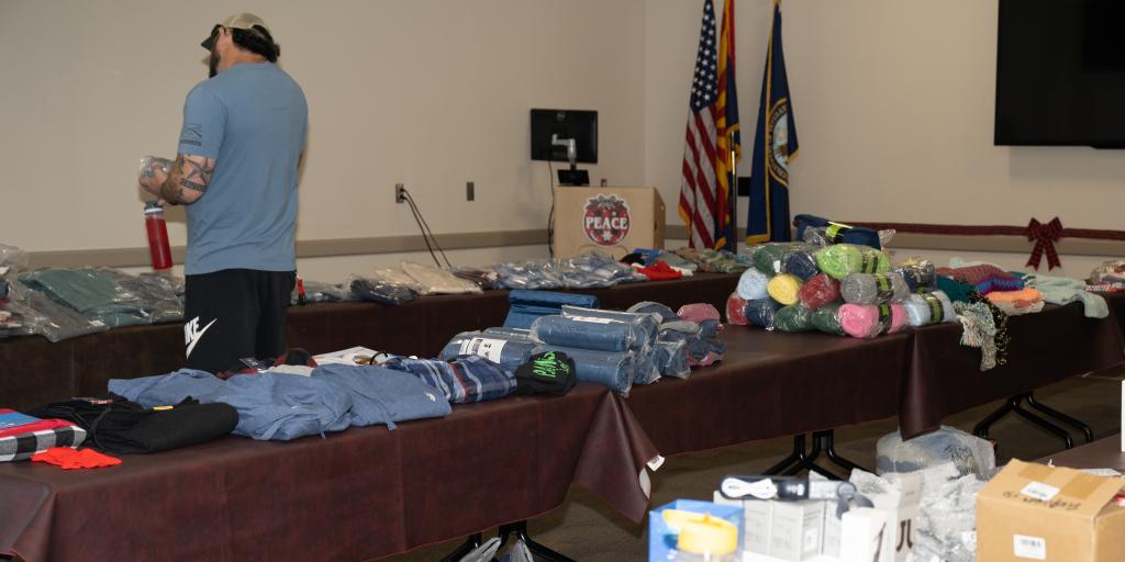 A man shopping amongst tables with gift items on them.