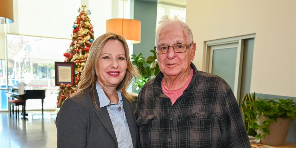 Nurse Lola smiles for a photo with a Veteran at VA Loma Linda