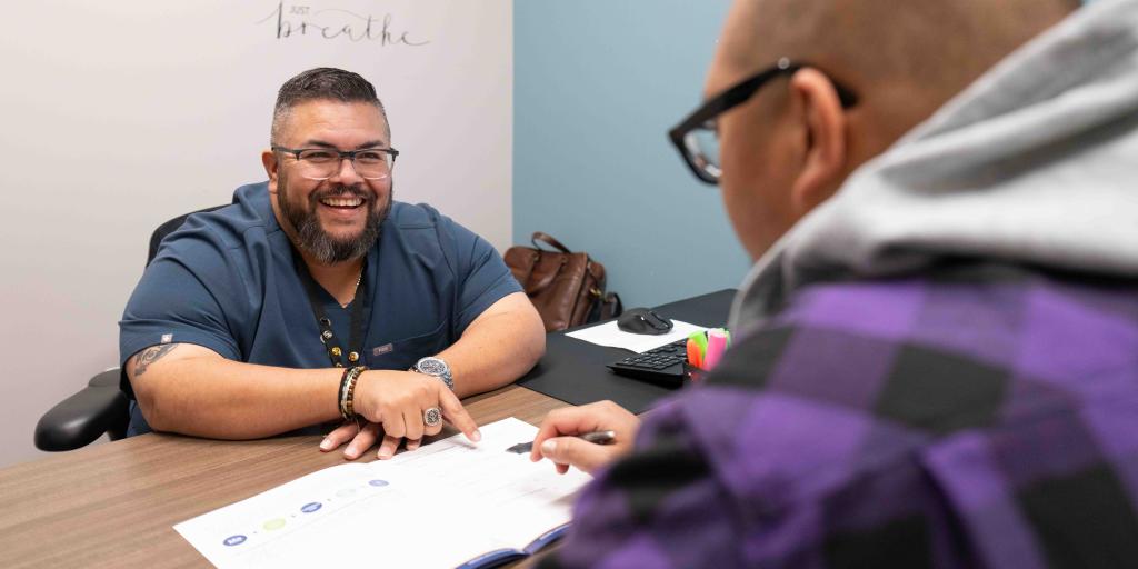 whole health coach guides veteran using booklet