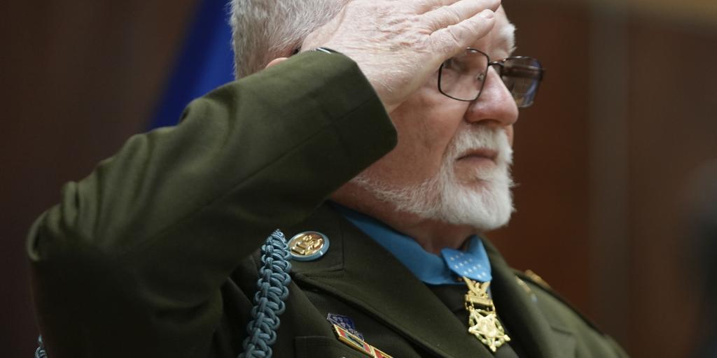Medal of Honor Kenneth J. David salutes during during a Vietnam War Veteran Day commemoration at Cleveland VA Medical Center