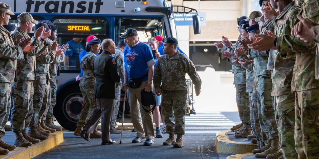Major Gen. Francis Evon greet veterans at an Honor Flight Bus to visit the war memorials in Washington D.C.