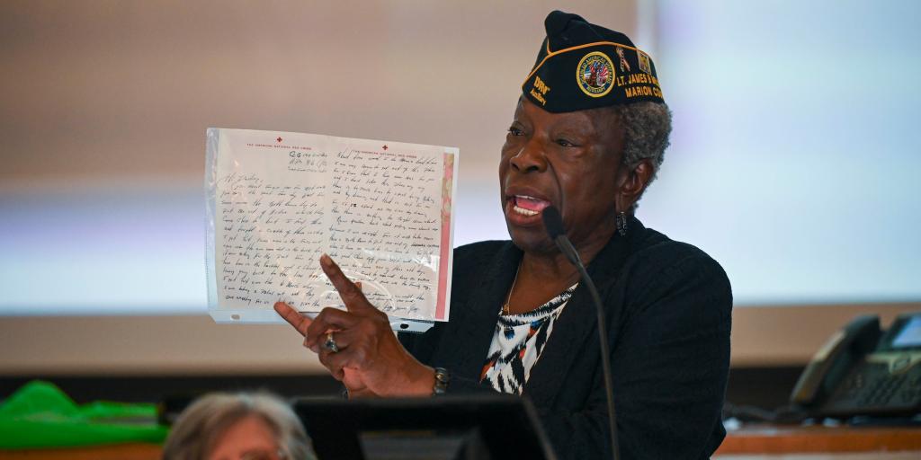 Miller’s sister, Mary Miles, holds a letter her brother sent home from a field hospital in 1953 while stationed in South Korea.