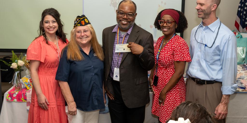 Dr. Ladi Kukoyi, Birmingham VA Executive Director, accepts $500 donation check to the Women's Health Program
