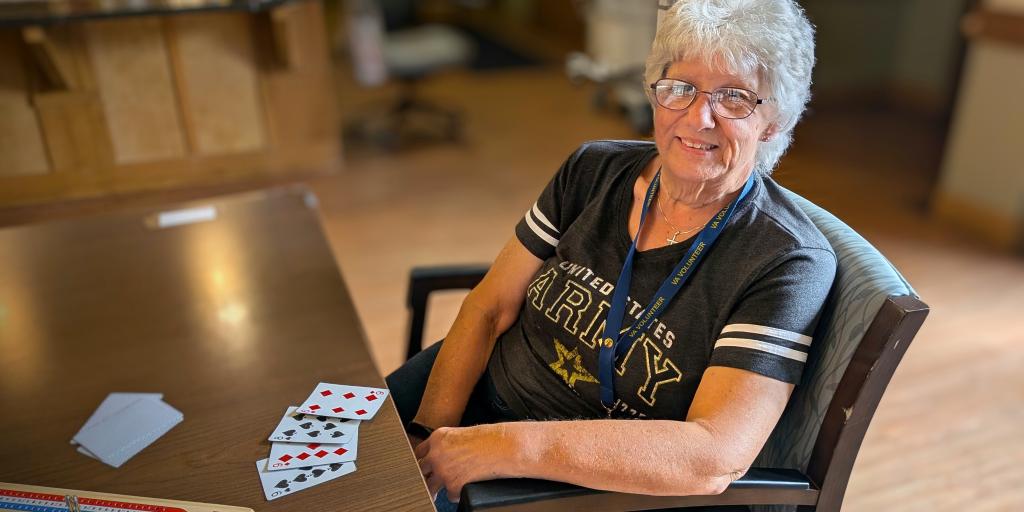 Sharon Bayless takes a break from playing cribbage with a Veteran in the Milwaukee VA’s Community Living Center.