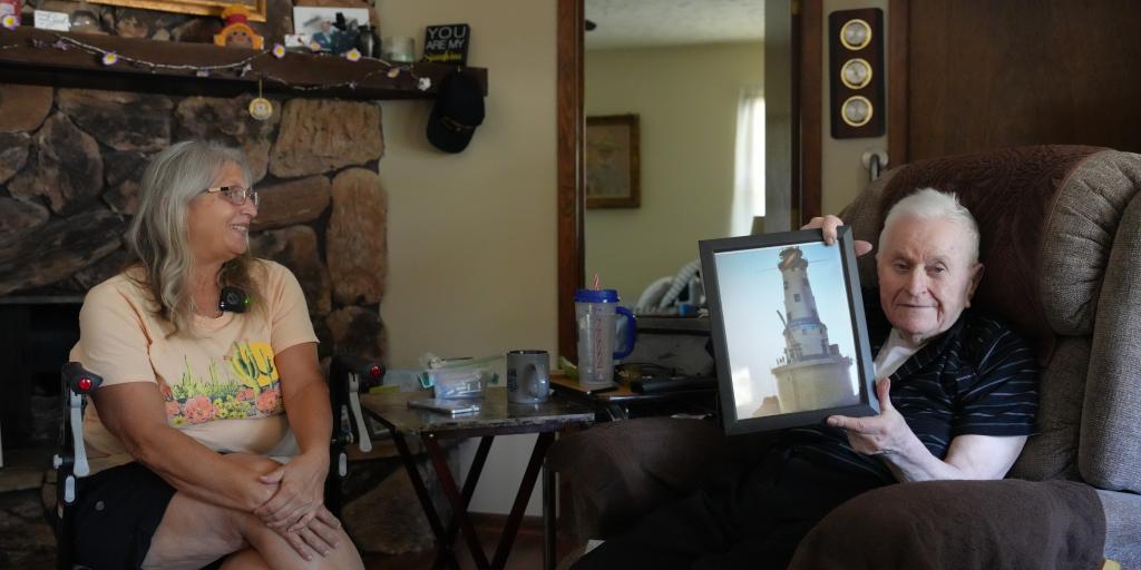 Ron Gasper recalls the memories of his time at the Rock of Ages Lighthouse while his daughter Sue looks on. 