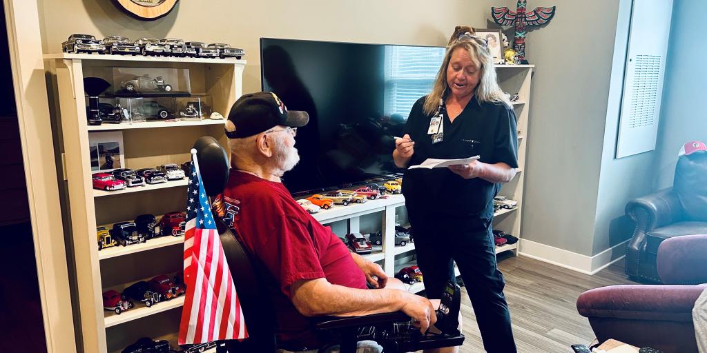 Home-based care nurse meets with patient