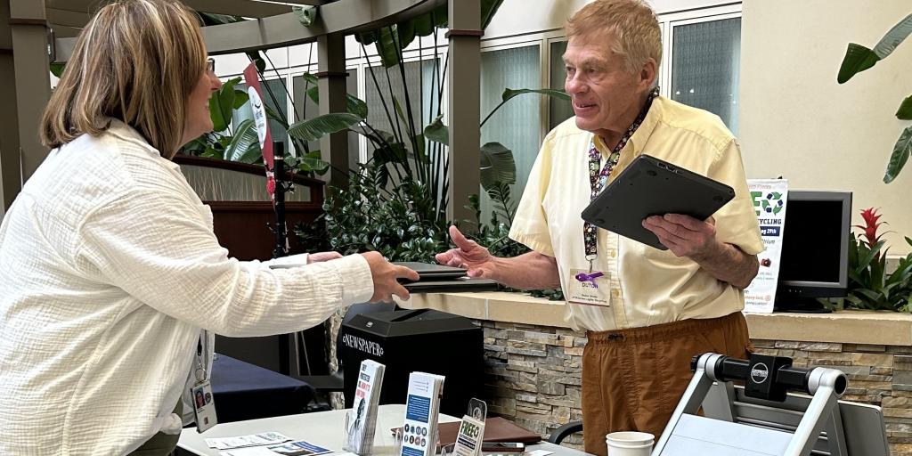 two people recycling electronics