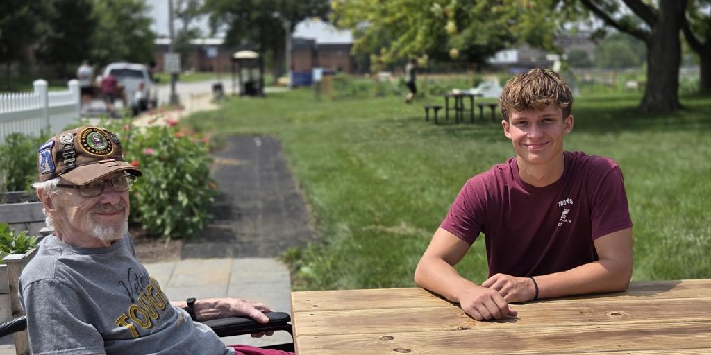 Haden Toenjes and his grandfather enjoy the Hines Community Living Garden. 