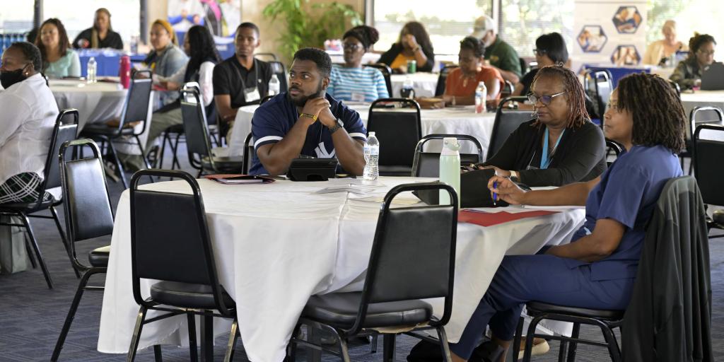 people sitting around tables at summit