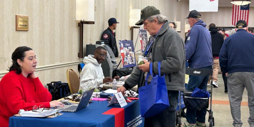 VA Providence's Jeannine Ahart assists a Veteran with VA Enrollment during the Stand Down event.