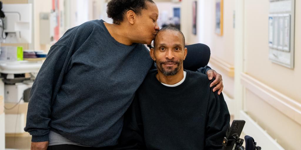 Crystal Jackson kisses her brother on the head