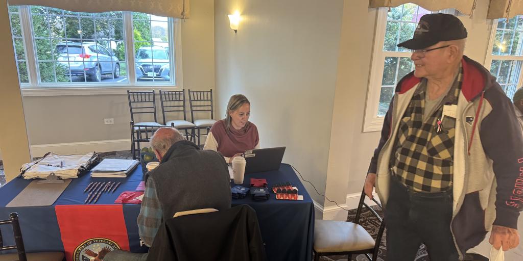 VA Providence's Joanne Barrett assists two Veterans with VA enrollment.