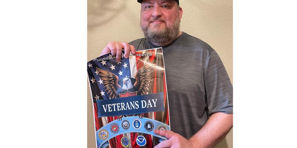 Veteran Jeremy Carpenter holding his winning poster