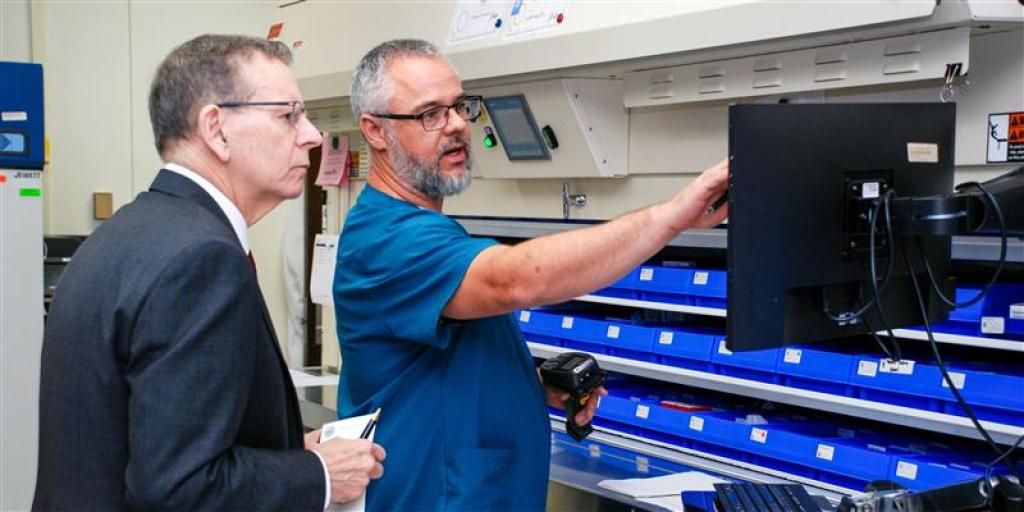 VA Deputy Secretary Paul R. Lawrence, Ph.D., talks to a Fort Wayne Pharmacy Technician Supervisor Tim Sanger during recent visit to VANIHCS.