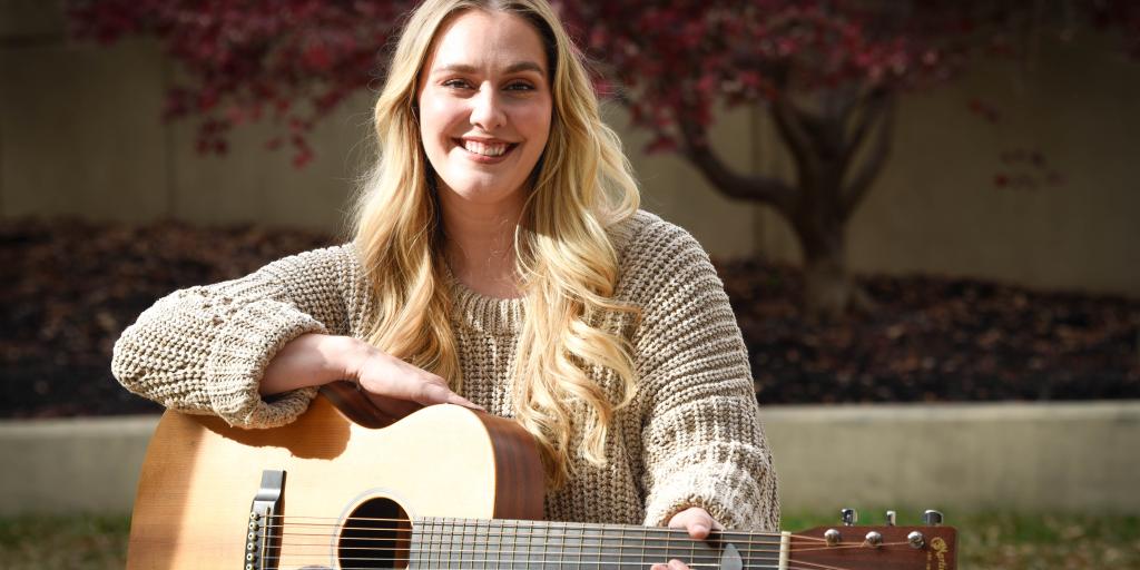 VHSO social worker holding her guitar