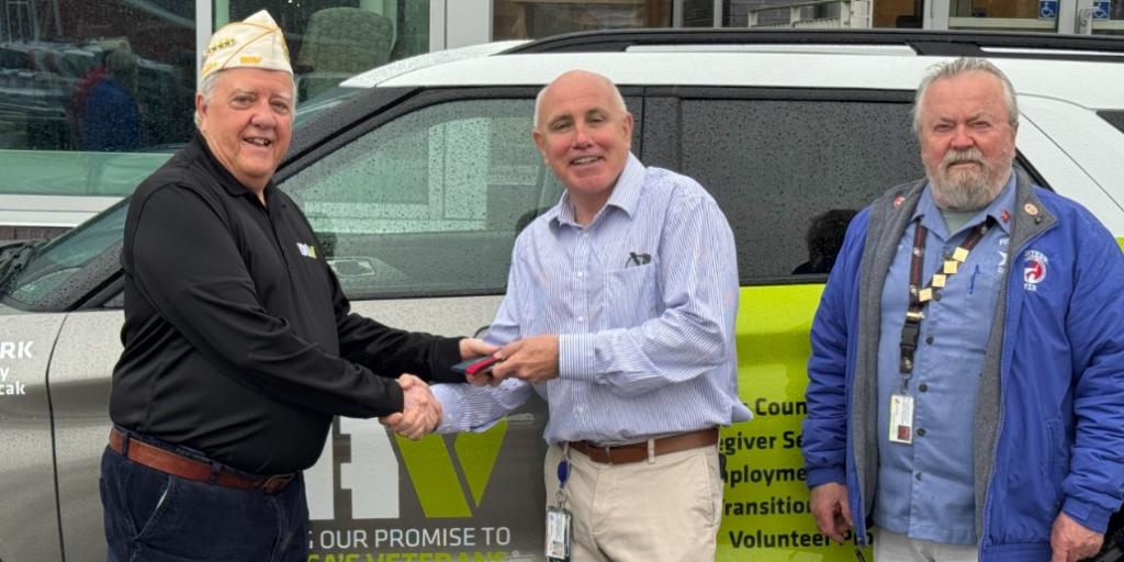 VA Providence Director Lawrence Connell accepts the keys from DAV Leadership.