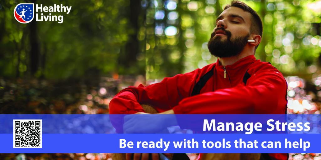 A man sitting relaxed in a forest, looking skyward with his eyes closed.