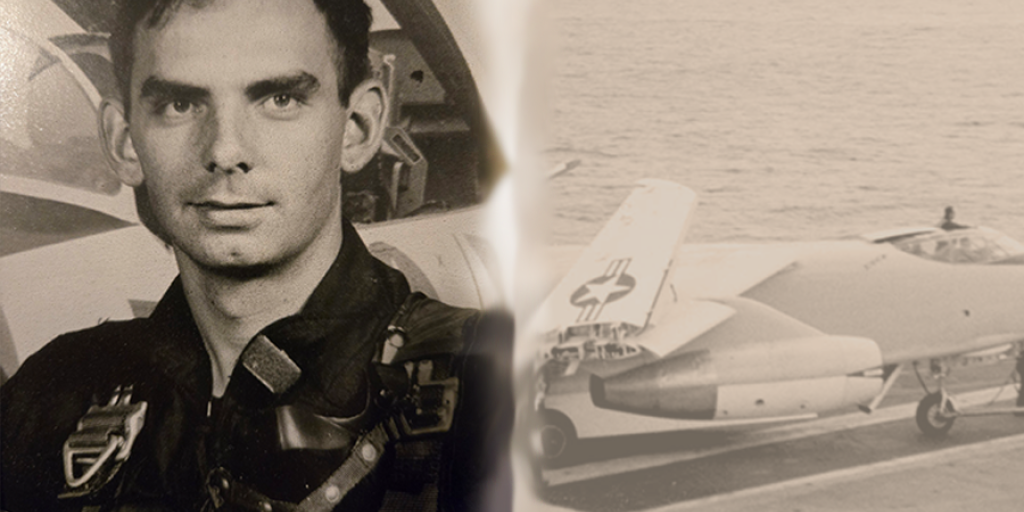 a man with short dark hair and dark eyebrows in a Navy uniform along side refueling aircraft in flight