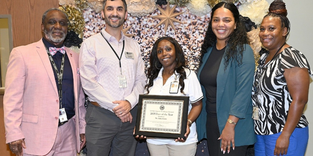 Edna J. Curry poses for a group photo with colleagues after receiving her award.