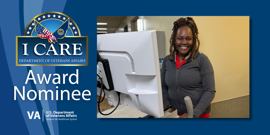 Woman in gray jacket stands behind computer with "I CARE Award Nominee" text.
