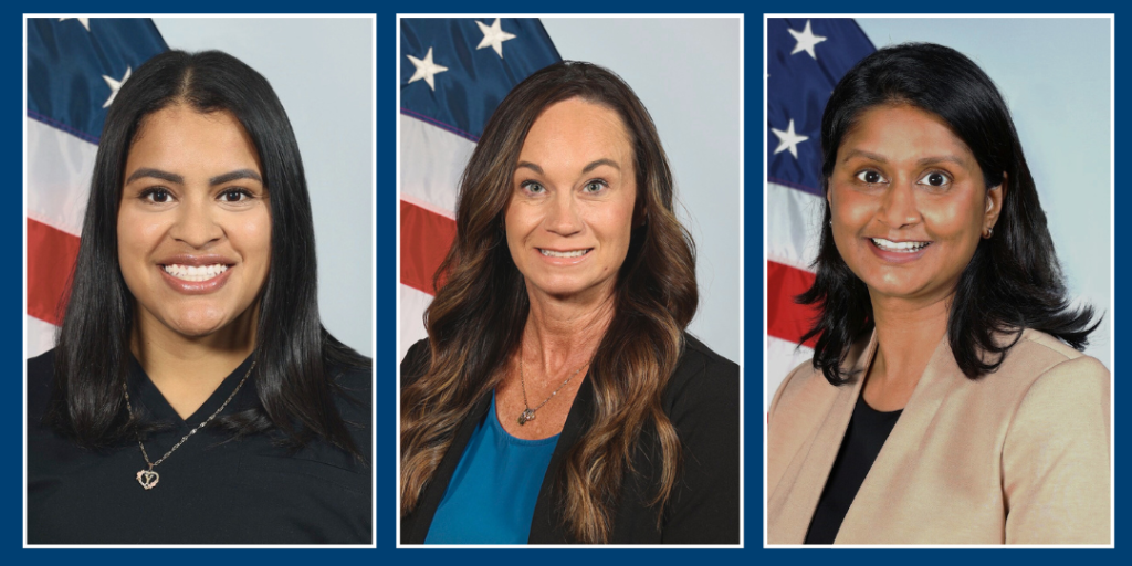 Three female employees of the year, each with a flag behind them.