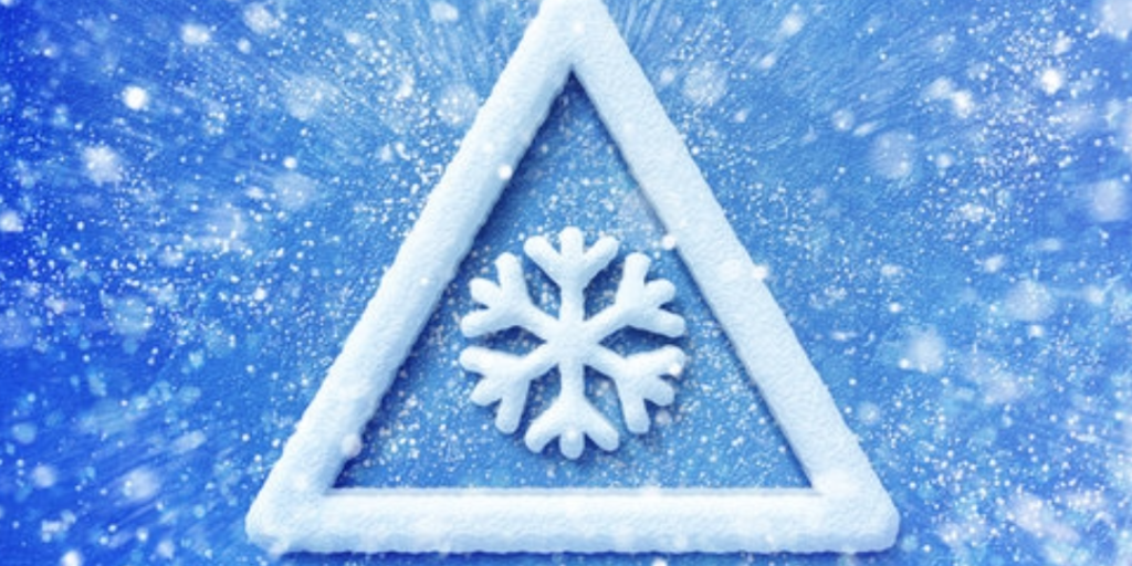 White triangle with a snowflake in the center on a blue background.