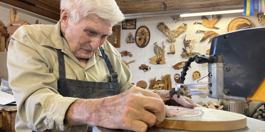 Air Force Veteran Earl Fred works at his scroll saw in his Helena, Montana workshop. His art earned him an invitation to the National Veterans Creative Arts Festival. 