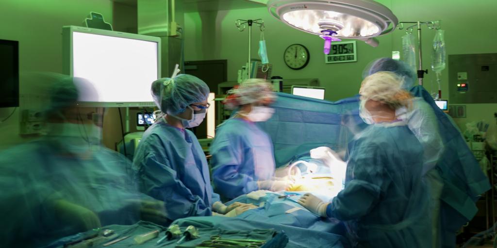 surgeons in an operating room performing surgery.