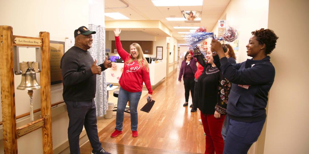 Group of people in a hallway celebrating with confetti.