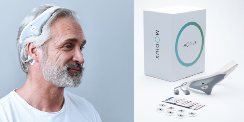 Older man wearing a headband and a box with various accessories.