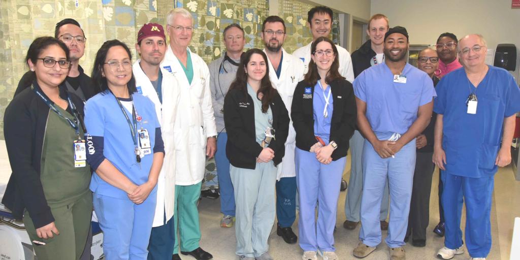 Group of hospital staff smiling for a photo.