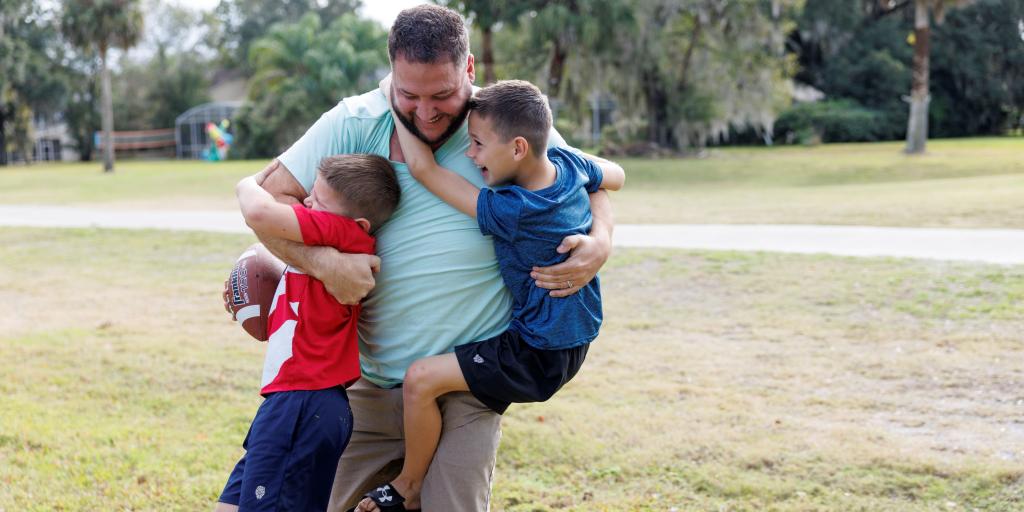 A Veteran and his two sons get active playing football in the yard. Routine activity is a key component of a healthy life. It doesn't have to be strenuous activity.