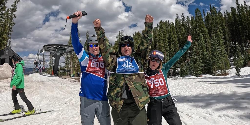 U.S. Air Force Veteran Salvador Vasquez (center), raises his arms in celebrations with ski instructors Bruce Tubbs (left) and Molly Nickel (right) after a successful ski run at Snowmass Village, Colorado during the National Disabled Veterans Winter Sports Clinic, April 6, 2026. 