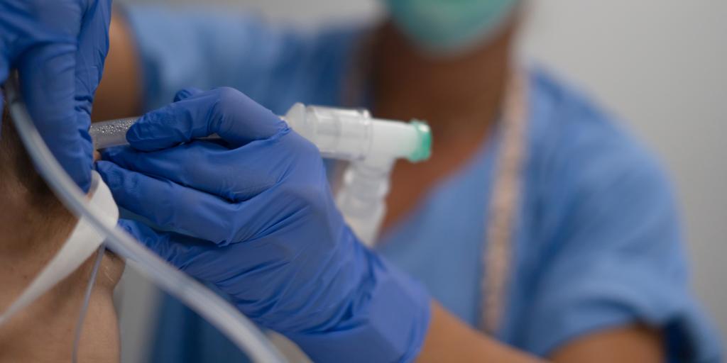 An anesthetist intubates a patient. Stock image from Getty Images..